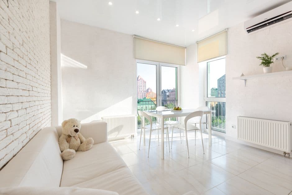 A white kitchen and living space with clean lines