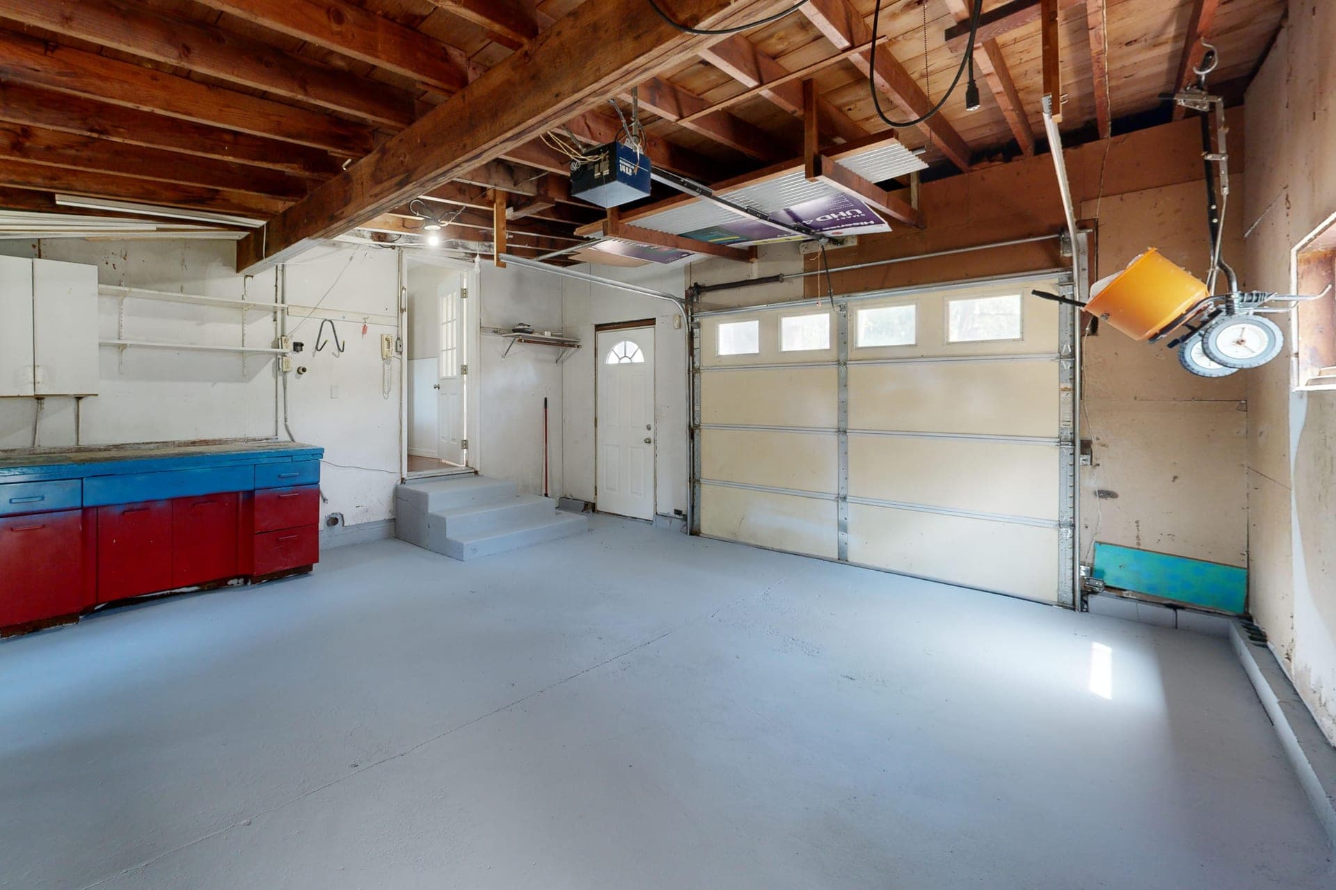 An empty garage interior with storage cabinets