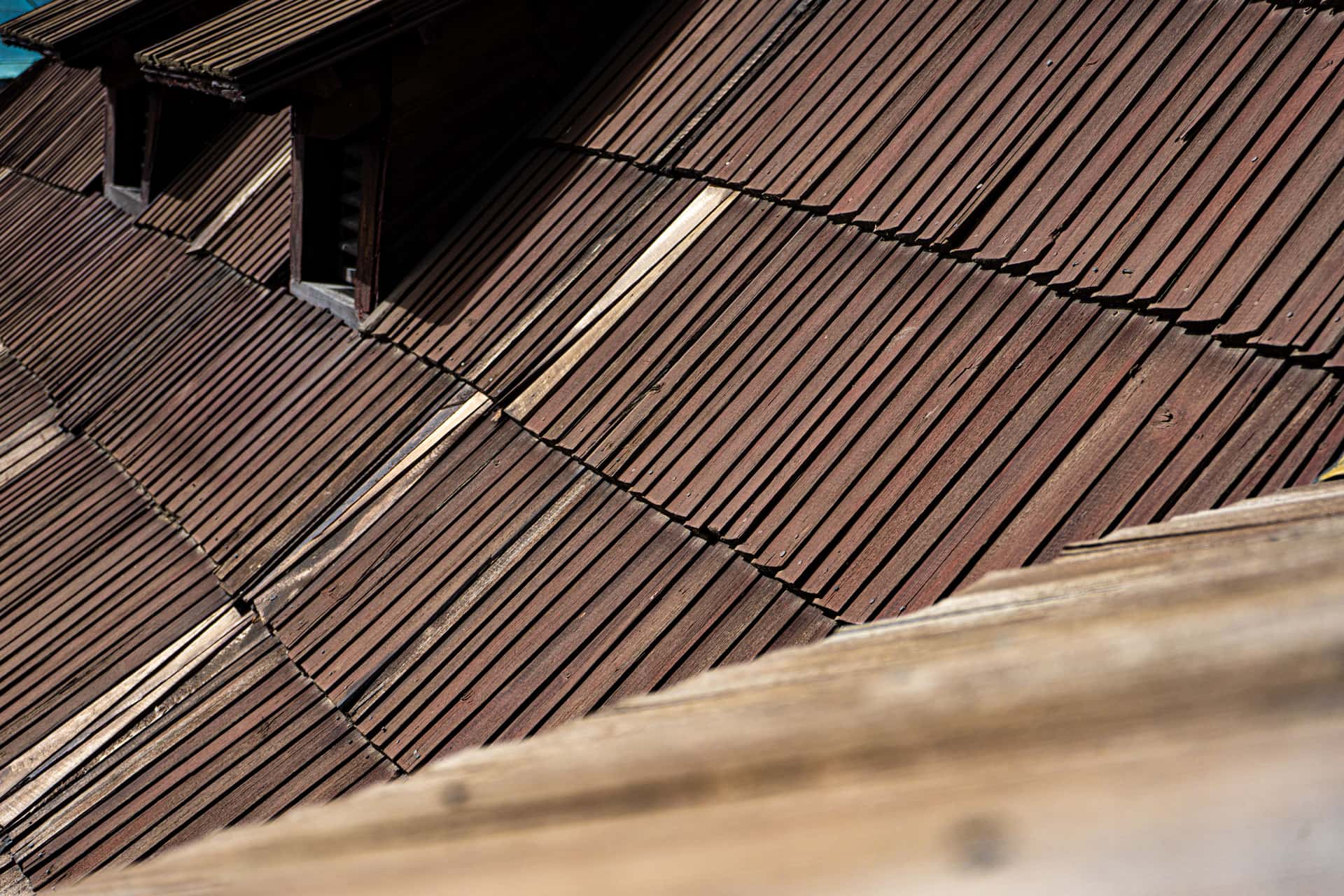 Aged wooden roof shingles seen close up