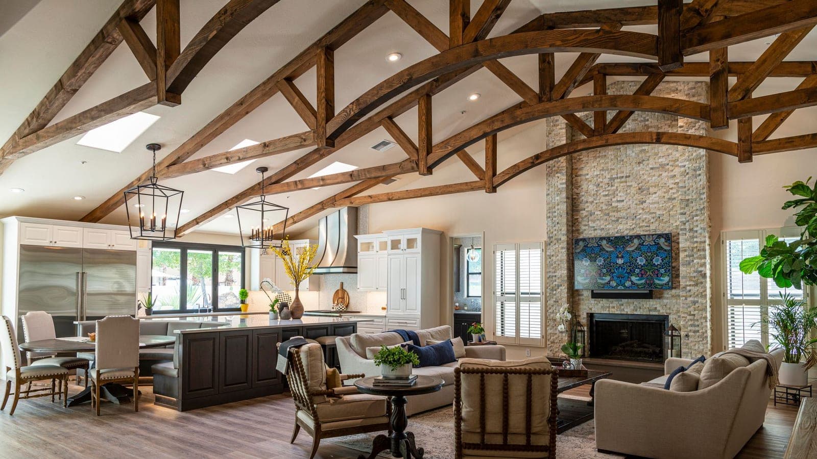 A vaulted living room ceiling with a large fan