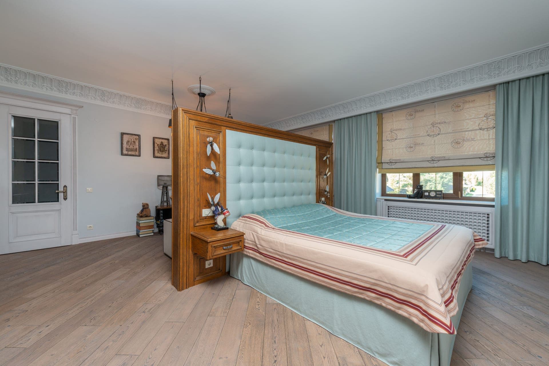A bedroom with wooden furniture and pastel decor