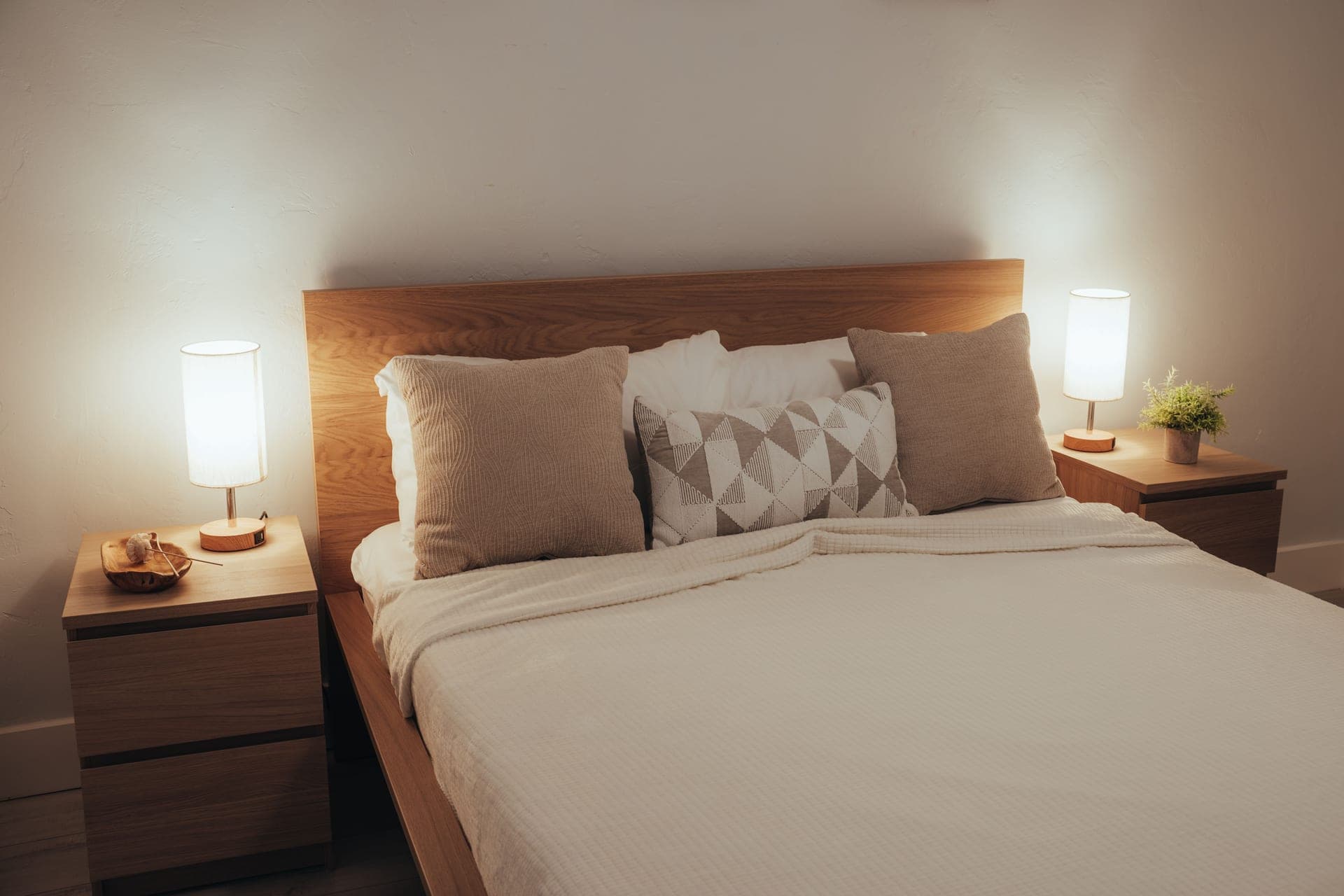 A minimalist bedroom with soft lighting and modern furniture