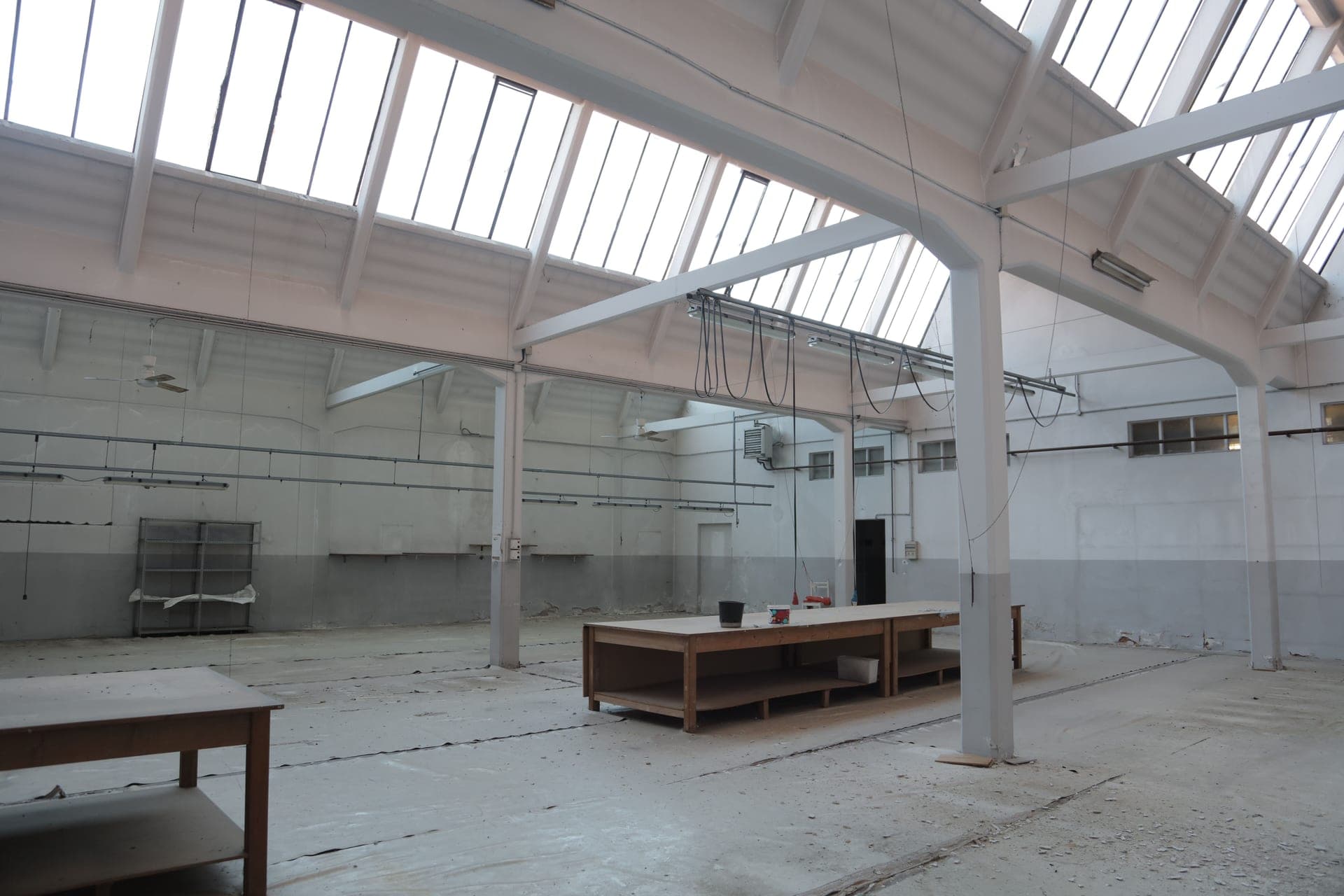 A bright industrial storage space with a concrete floor and metal beams