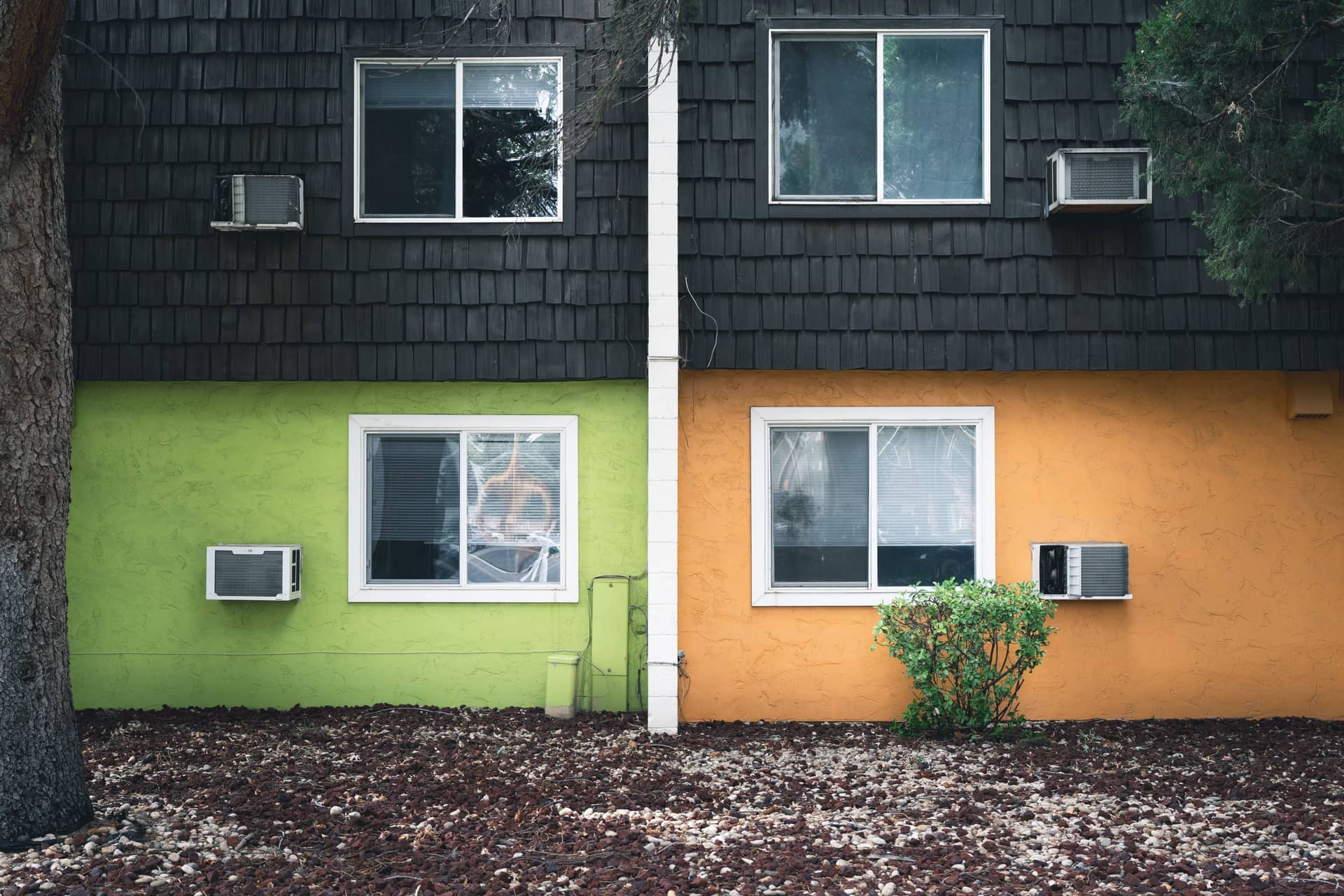 An apartment facade with wall-mounted air conditioning units