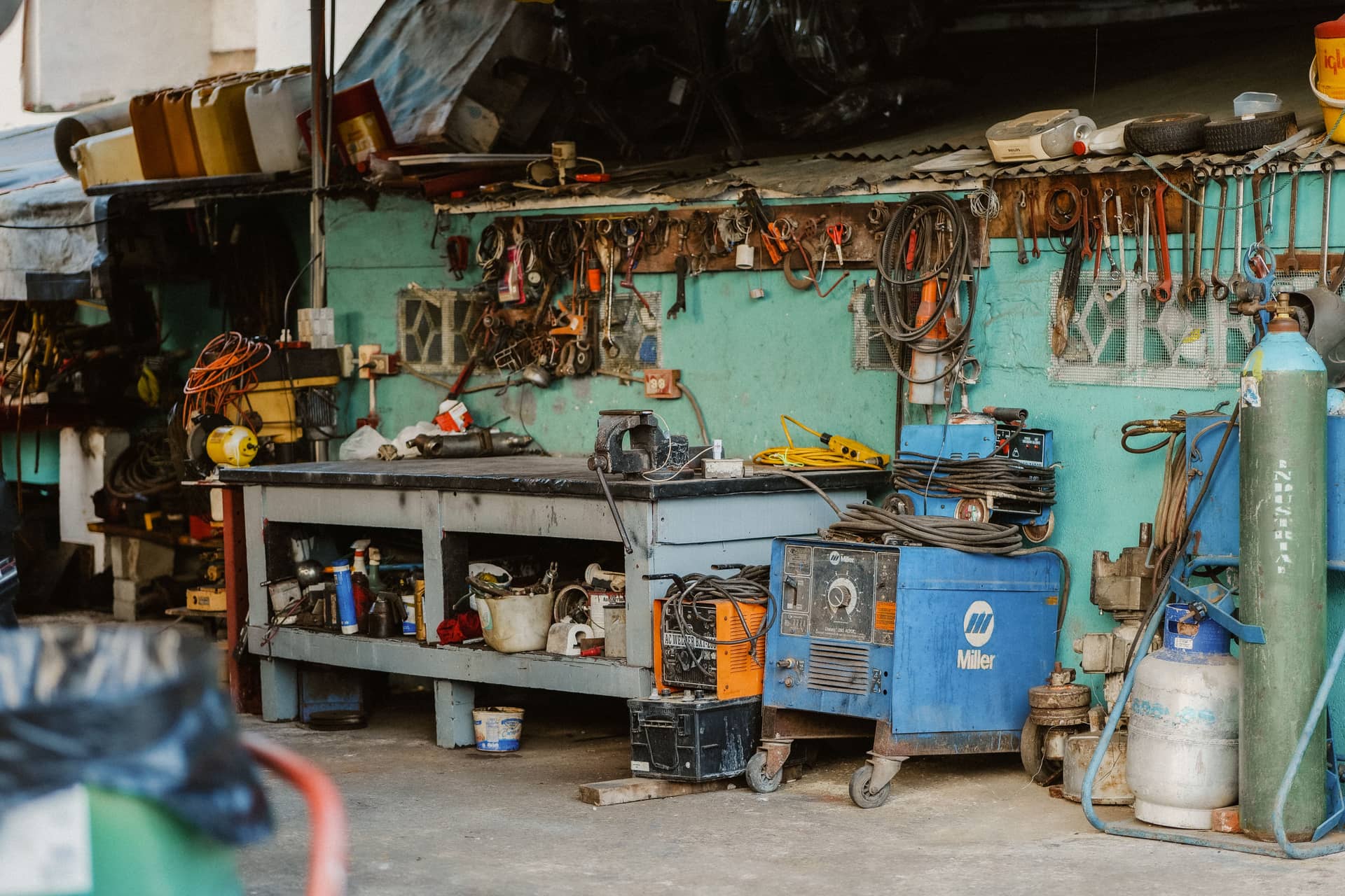 A workshop with tools, welding equipment and storage