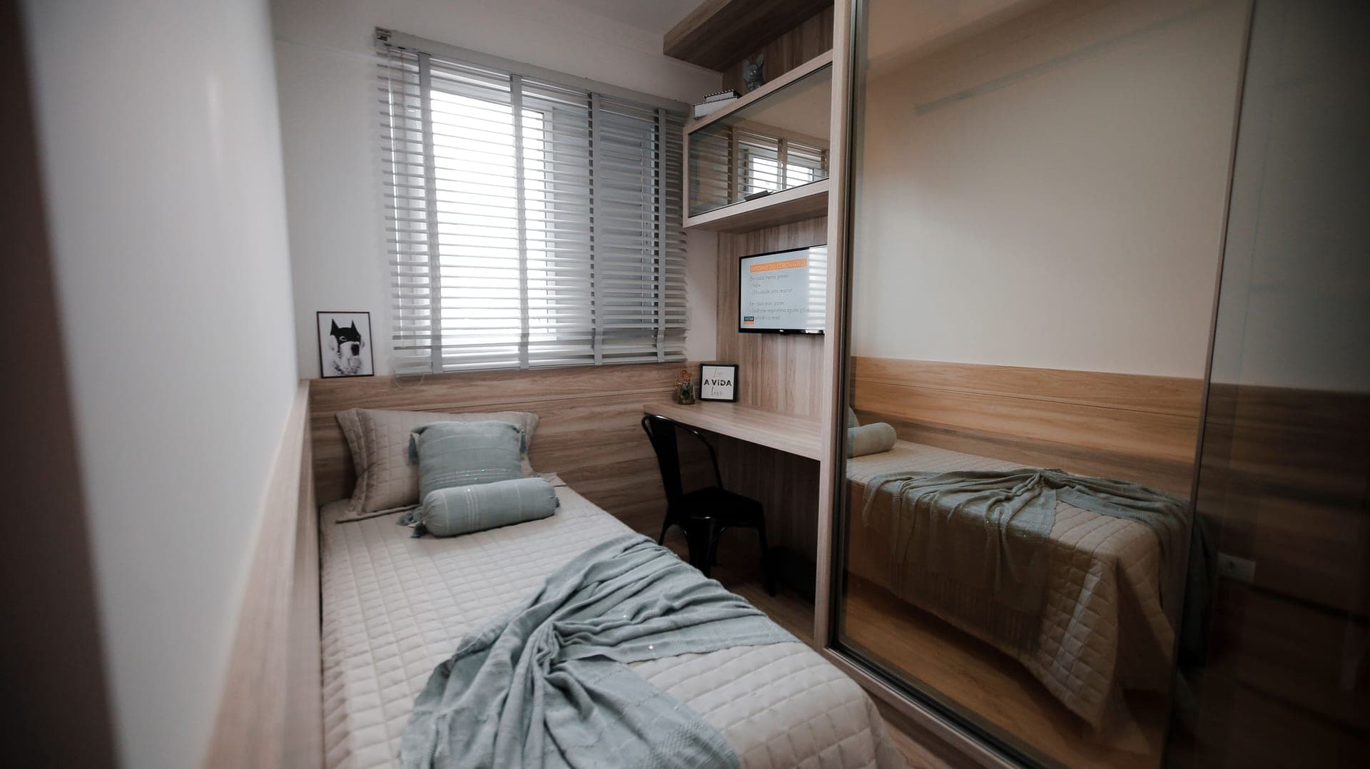 A small bedroom with a single window and afternoon light