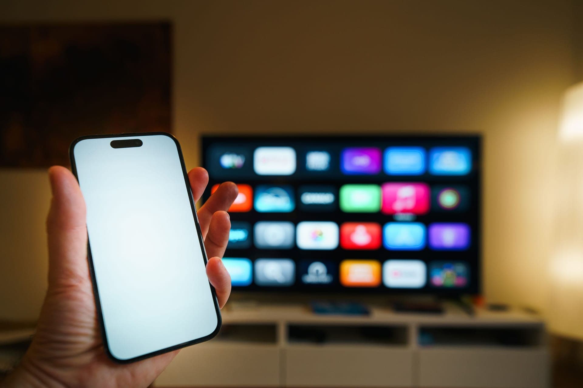 A phone being used to control a home appliance in a living room