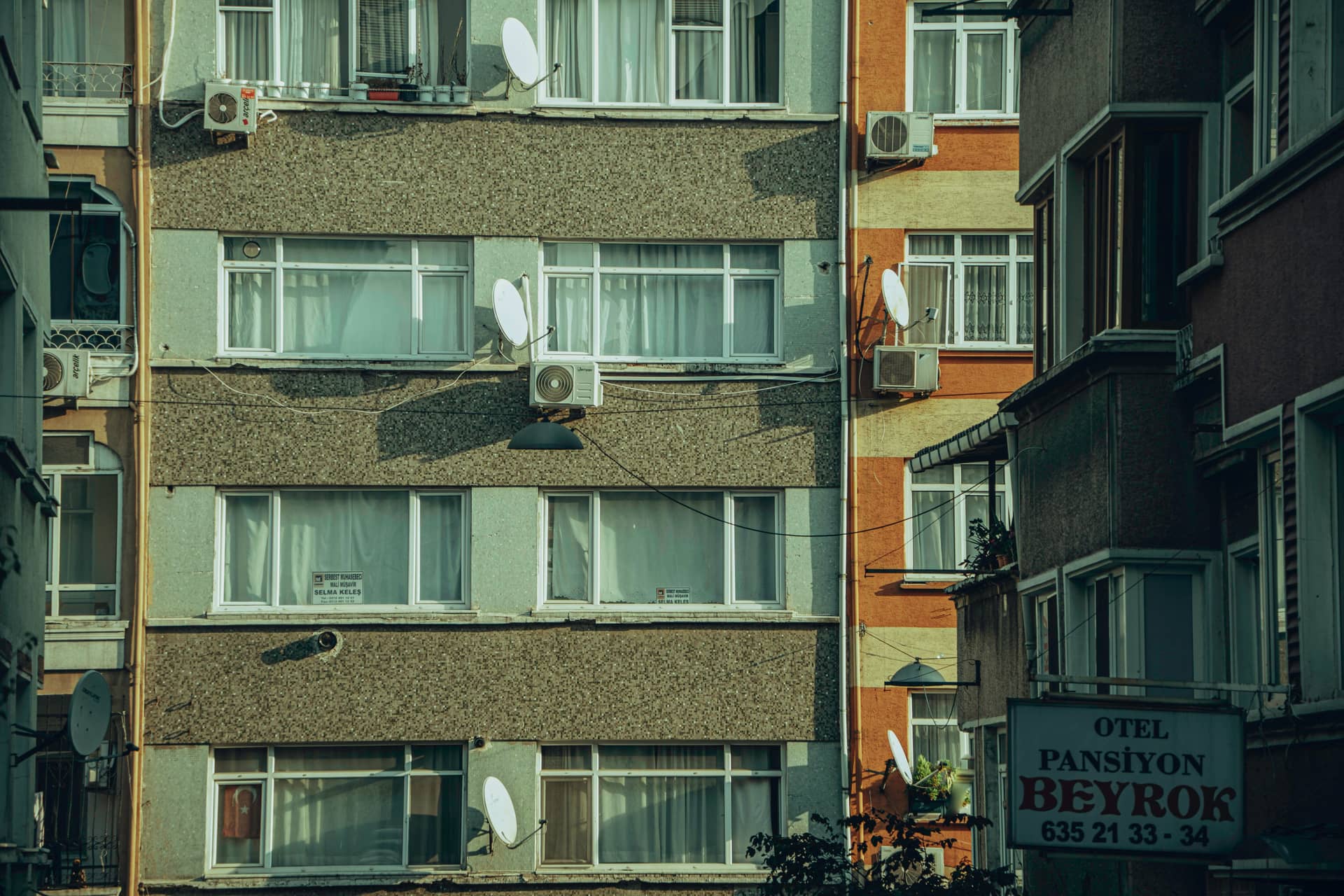 An urban apartment building with air conditioners on its facade