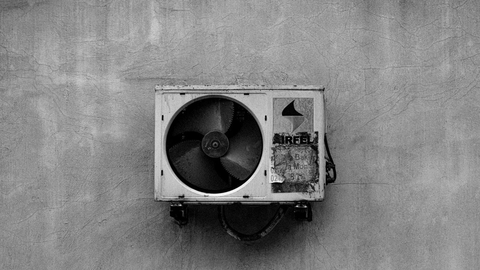 A wall-mounted fan in an industrial interior