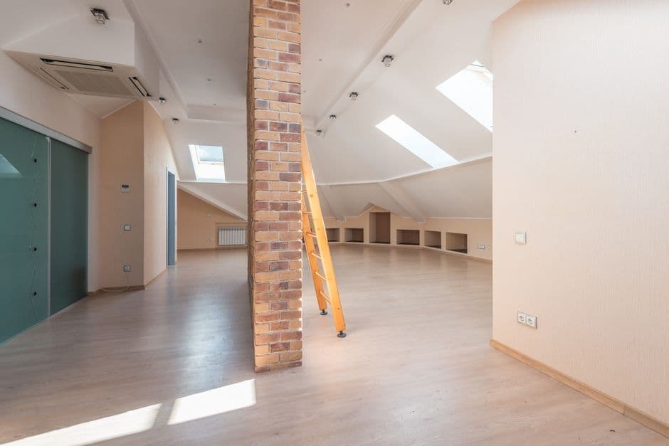 An attic space with light coming through roof windows