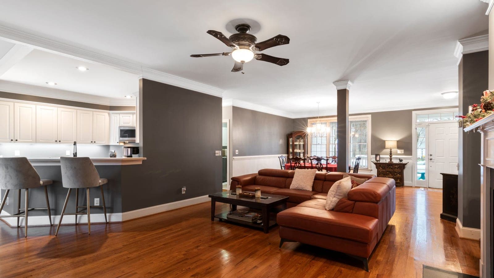 A living room with both a ceiling fan and a floor-standing fan