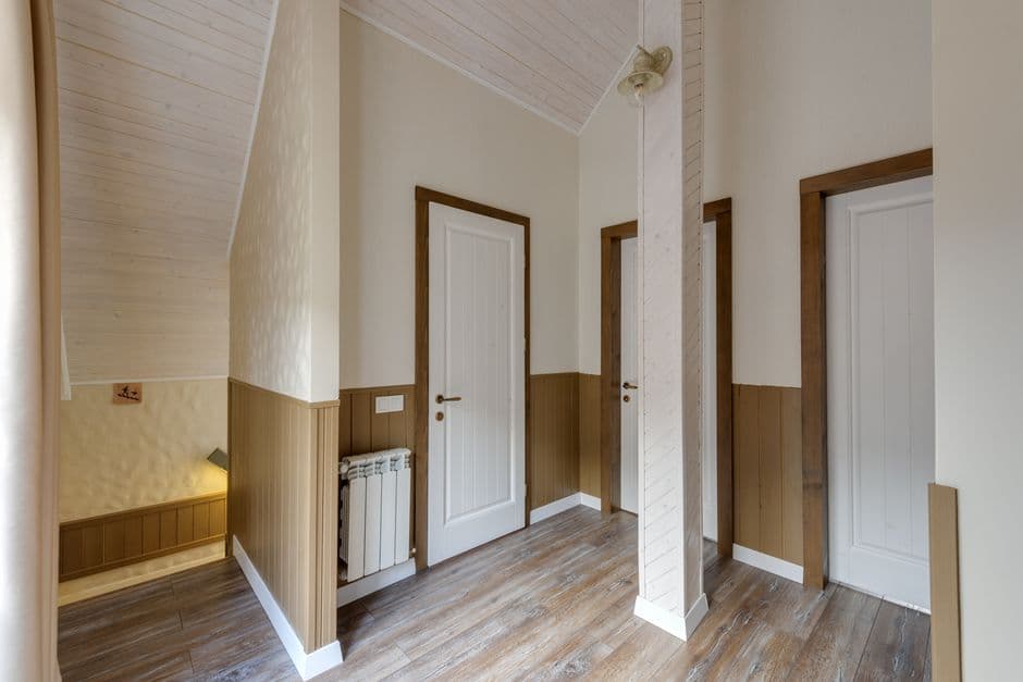 An empty hallway in a modern home with wooden doors