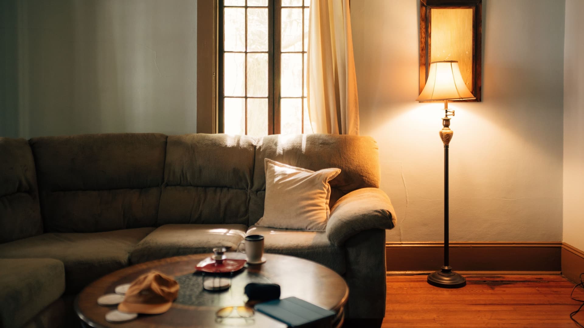 An interior room with no windows lit by a lamp