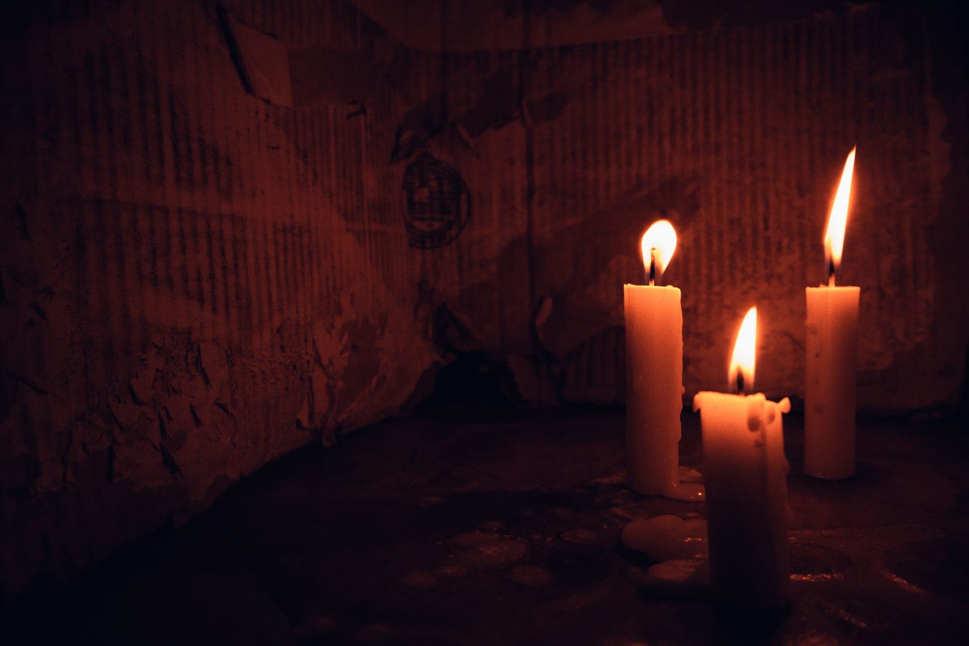 Candles burning in a dimly lit room