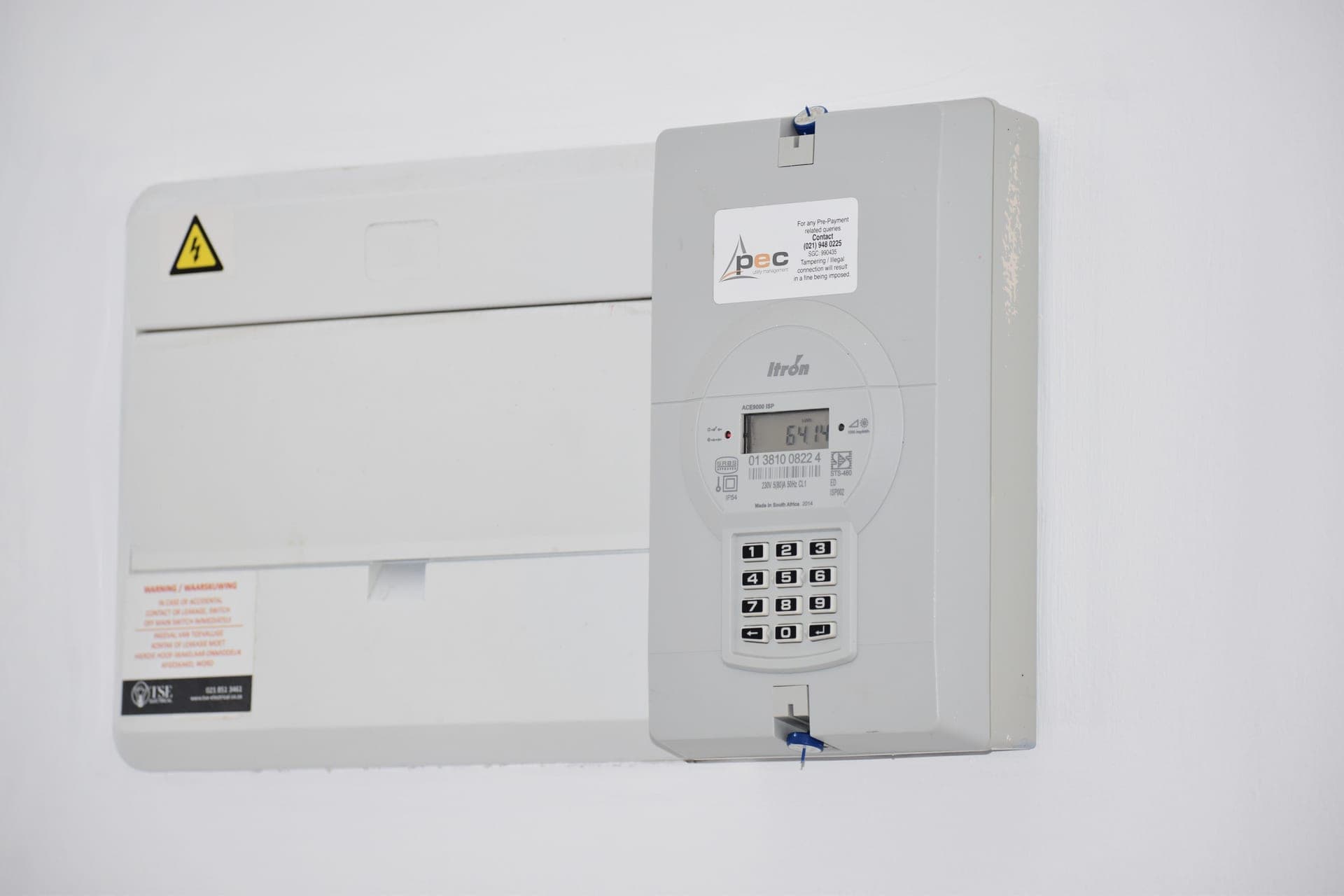 An electricity meter and a utility bill on a kitchen counter