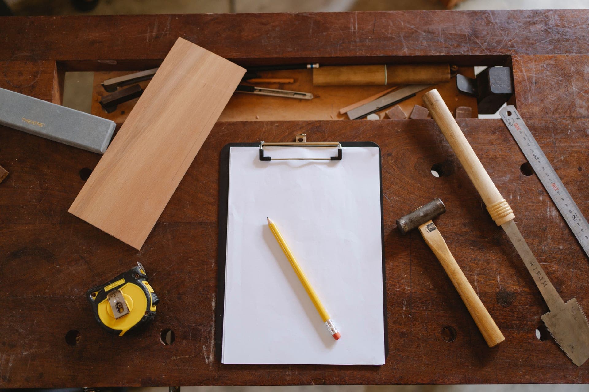 Carpentry tools laid out on a wooden workbench
