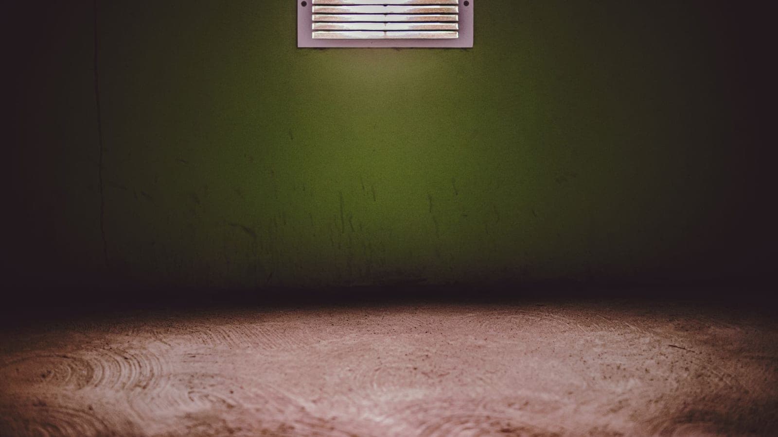 A floor supply register in a wooden floor