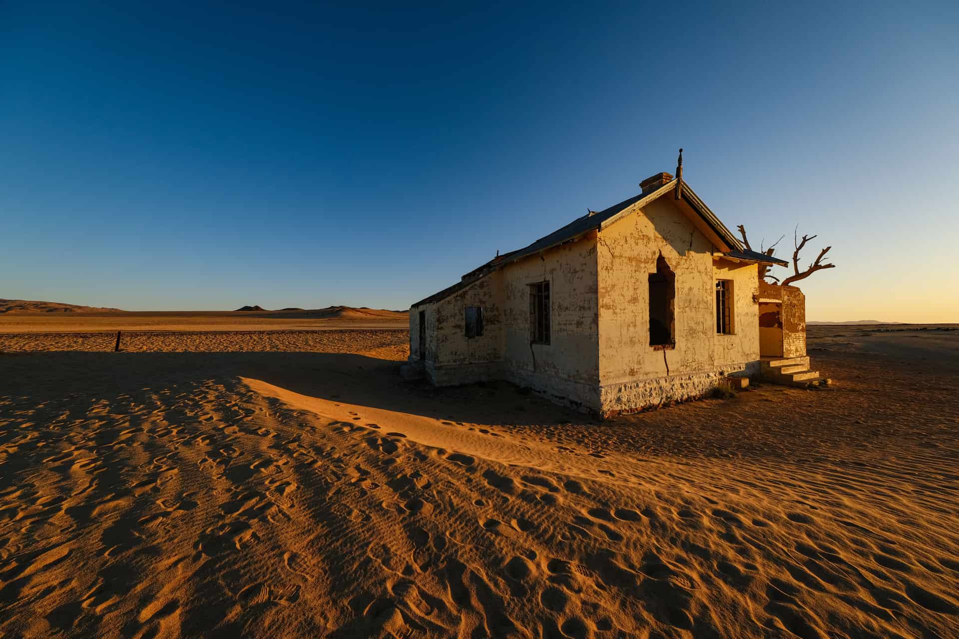 A single-story house exterior under strong dry-climate sunlight