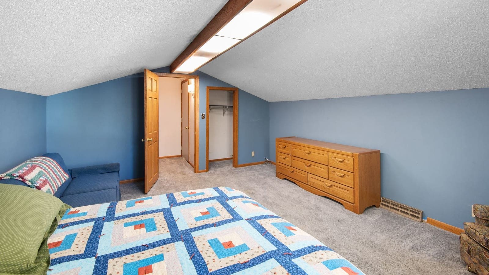 A finished attic room with a sloped ceiling