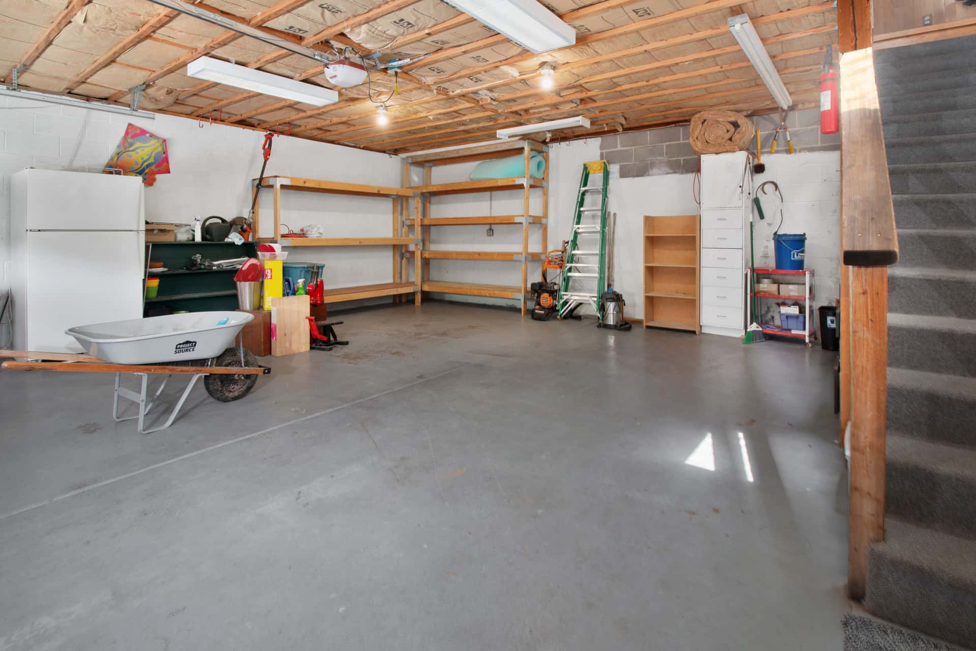 The interior of a home garage with a concrete floor
