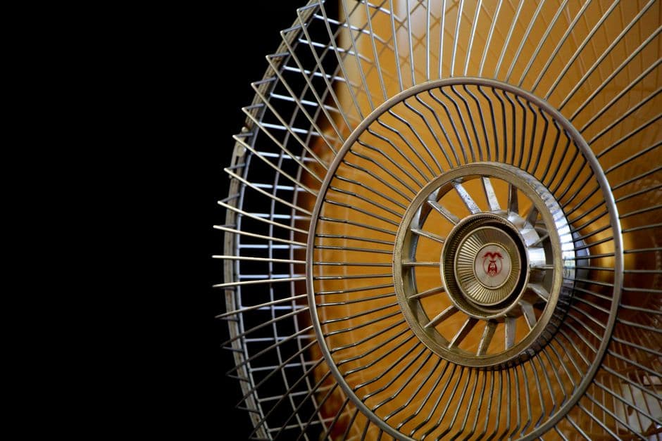 Close-up of an electric fan's blades and grille