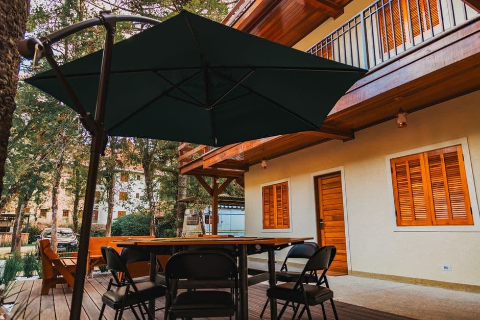 An outdoor patio with chairs, a table and a large umbrella