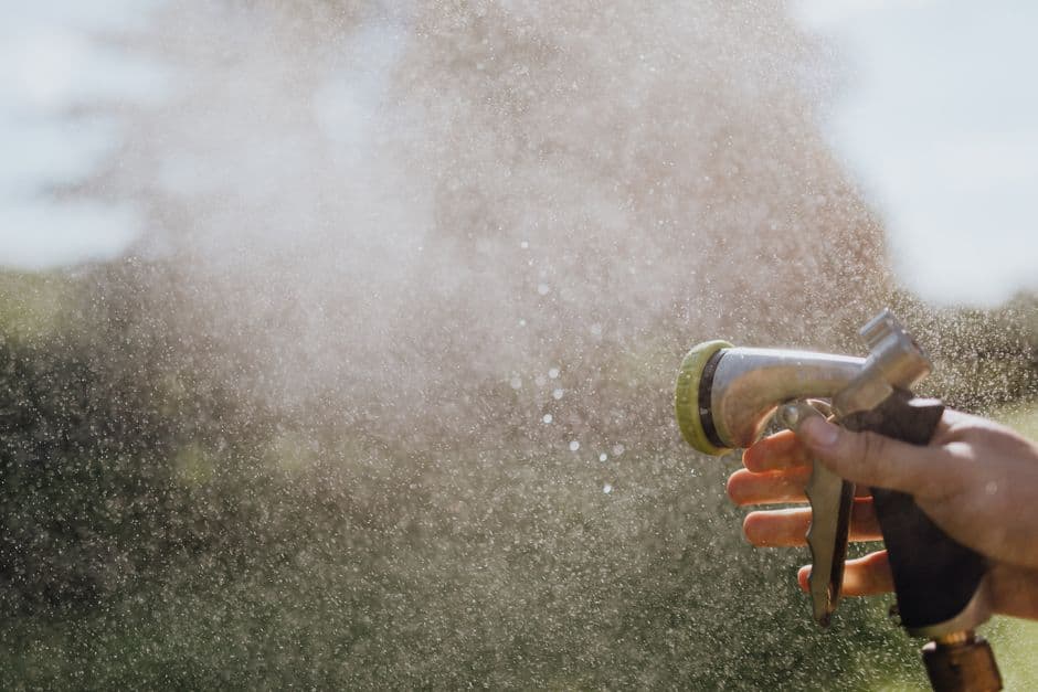 A garden hose nozzle spraying a fine mist of water
