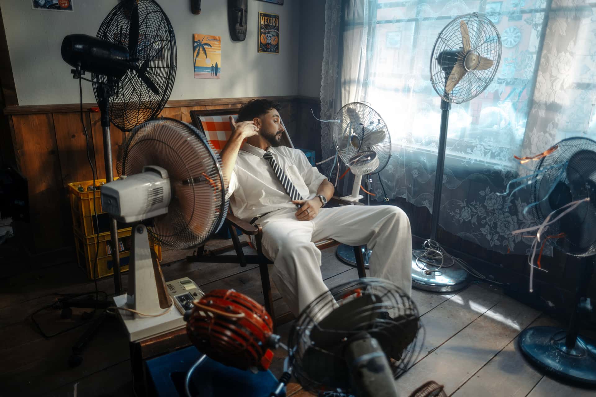 Two electric fans of different types standing in a room