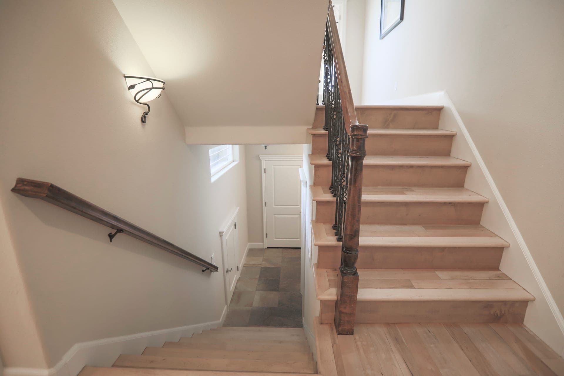 A staircase landing with daylight from an upstairs window