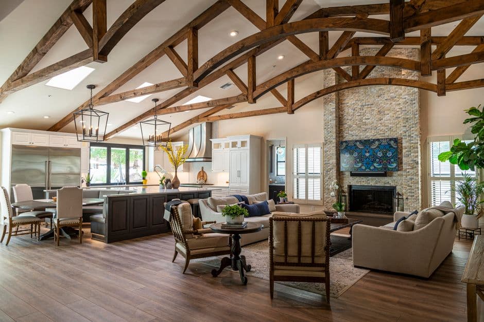 A living room with a vaulted ceiling and exposed wooden beams