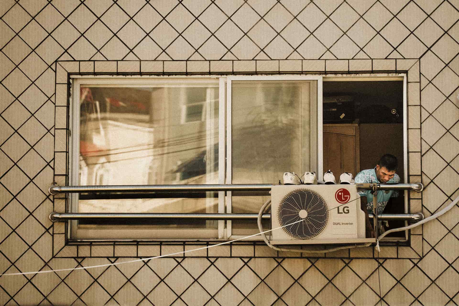 A window air conditioner seated in a lower sash window